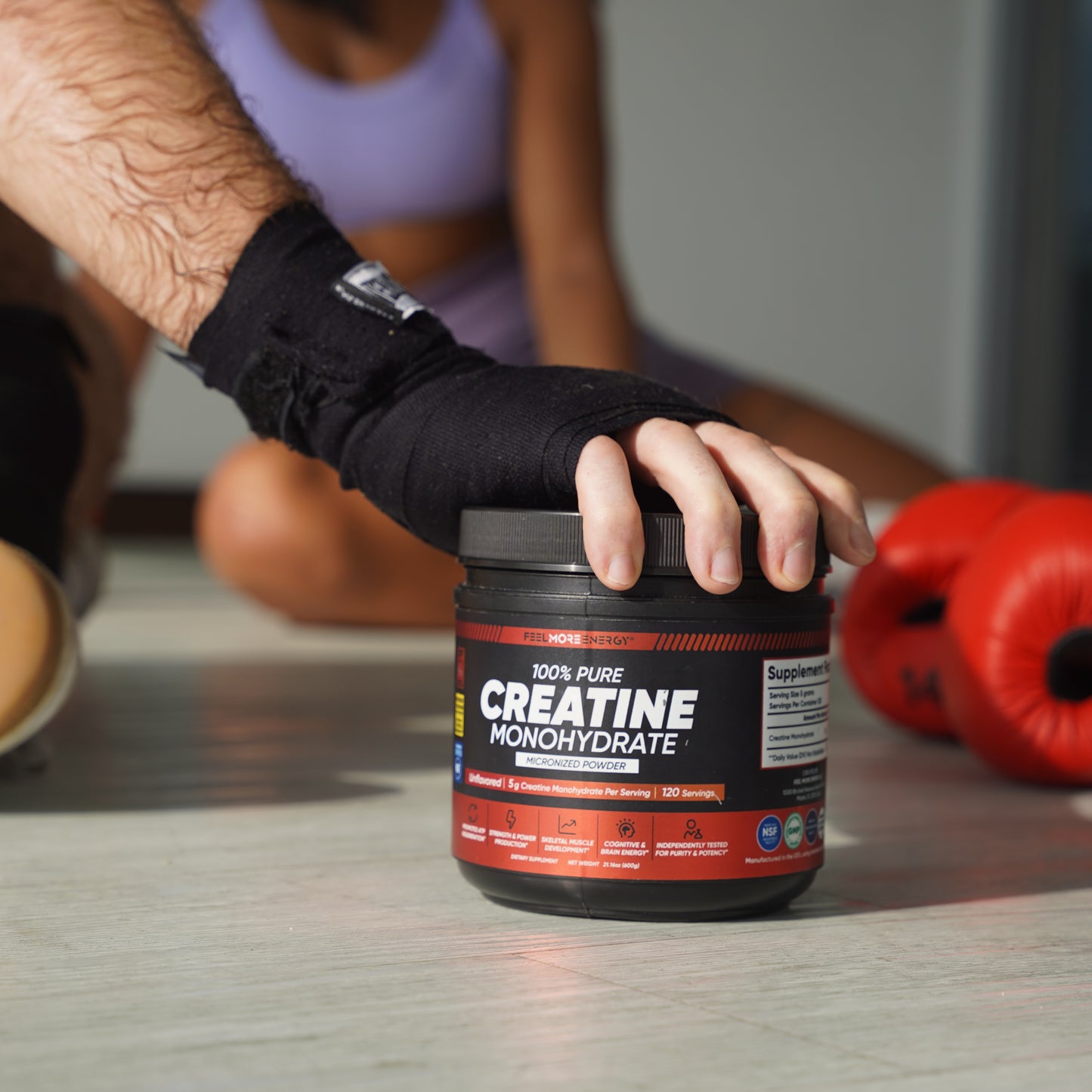 Athlete in training gloves scooping Feel More Energy creatine monohydrate — daily fuel for performance and recovery