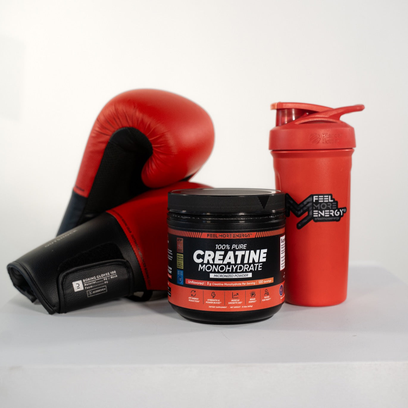 Feel More Energy creatine monohydrate jar with boxing gloves and gym equipment — engineered for serious strength athletes