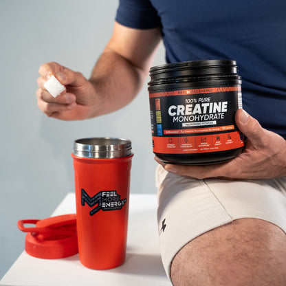Micronized creatine monohydrate powder being scooped from Feel More Energy jar — fine, fully soluble texture