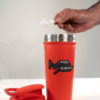 Pouring Feel More Energy creatine monohydrate into a shaker bottle — easy mixing for pre or post-workout intake