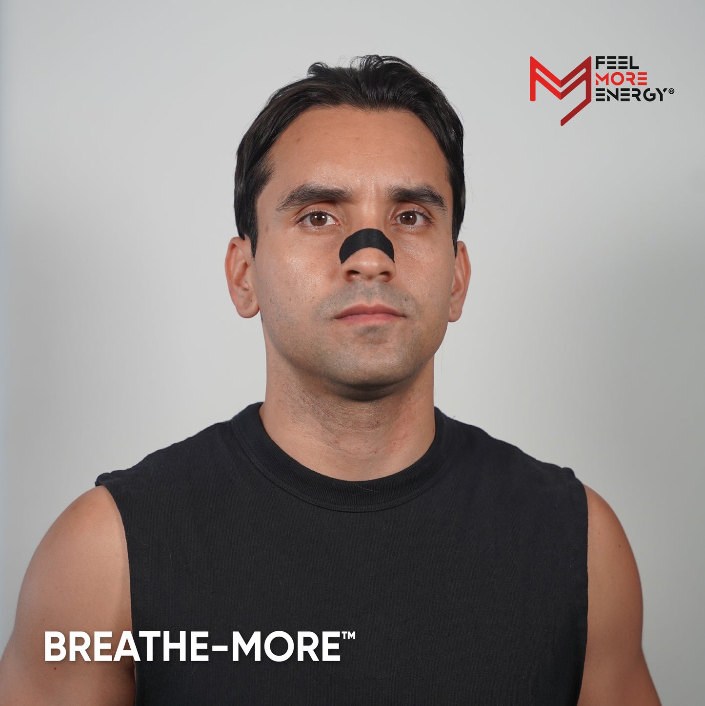Man wearing a black nose clip with 'BREATHE-MORE' branding on a gray background.