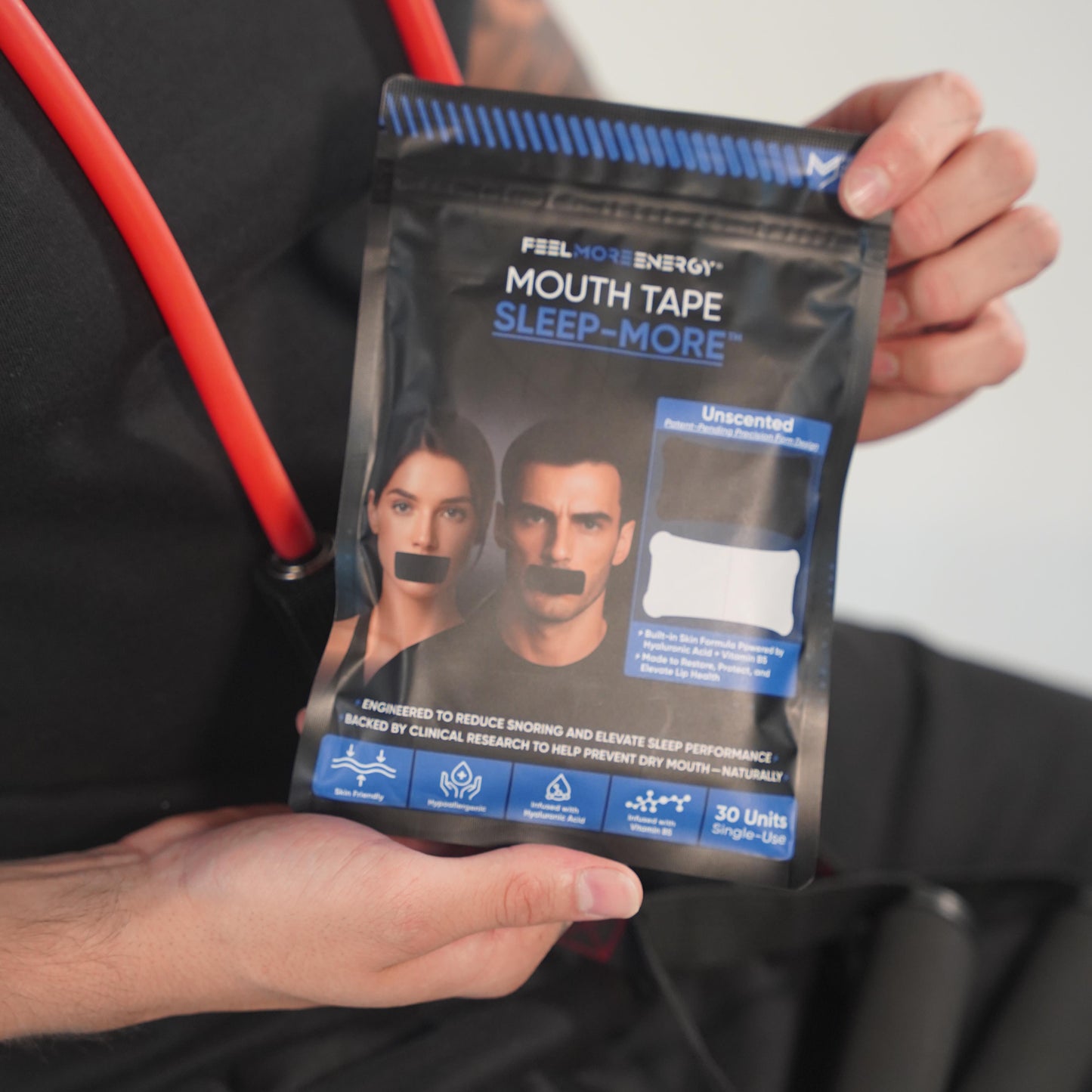  Athlete holding Sleep-More mouth tape — designed to optimize recovery through deeper, oxygen-rich sleep