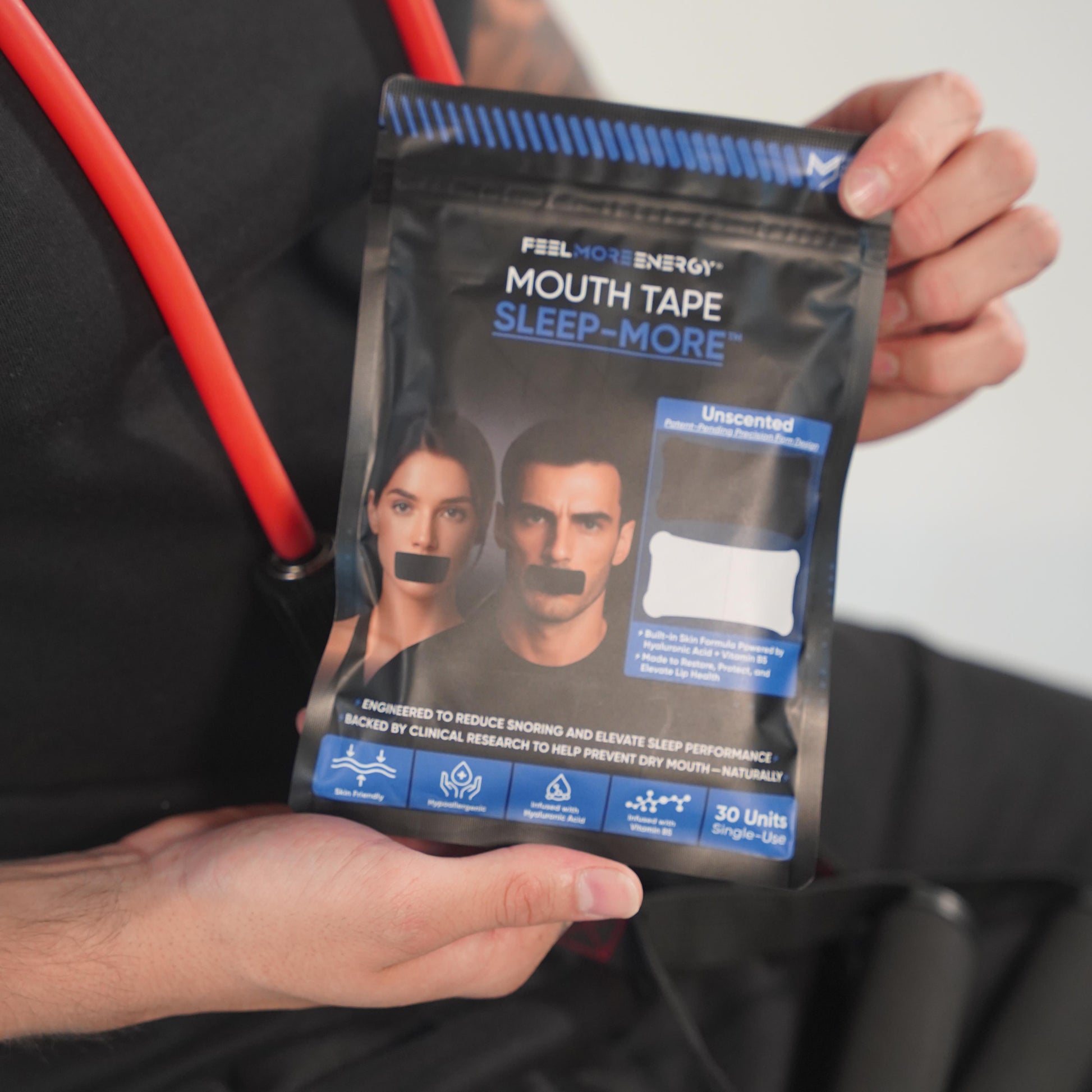 Athlete holding Sleep-More mouth tape — designed to optimize recovery through deeper, oxygen-rich sleep