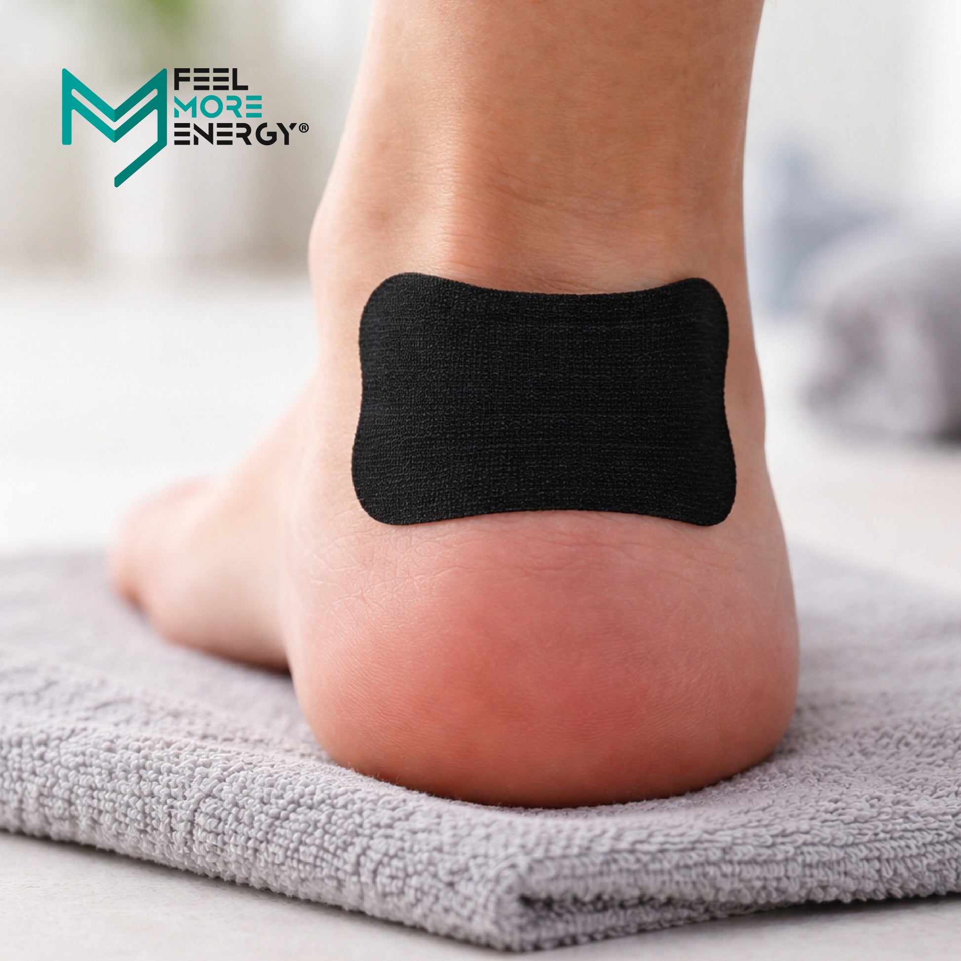 Black foot patch on a person's foot with 'Feel More Energy' logo in the corner.