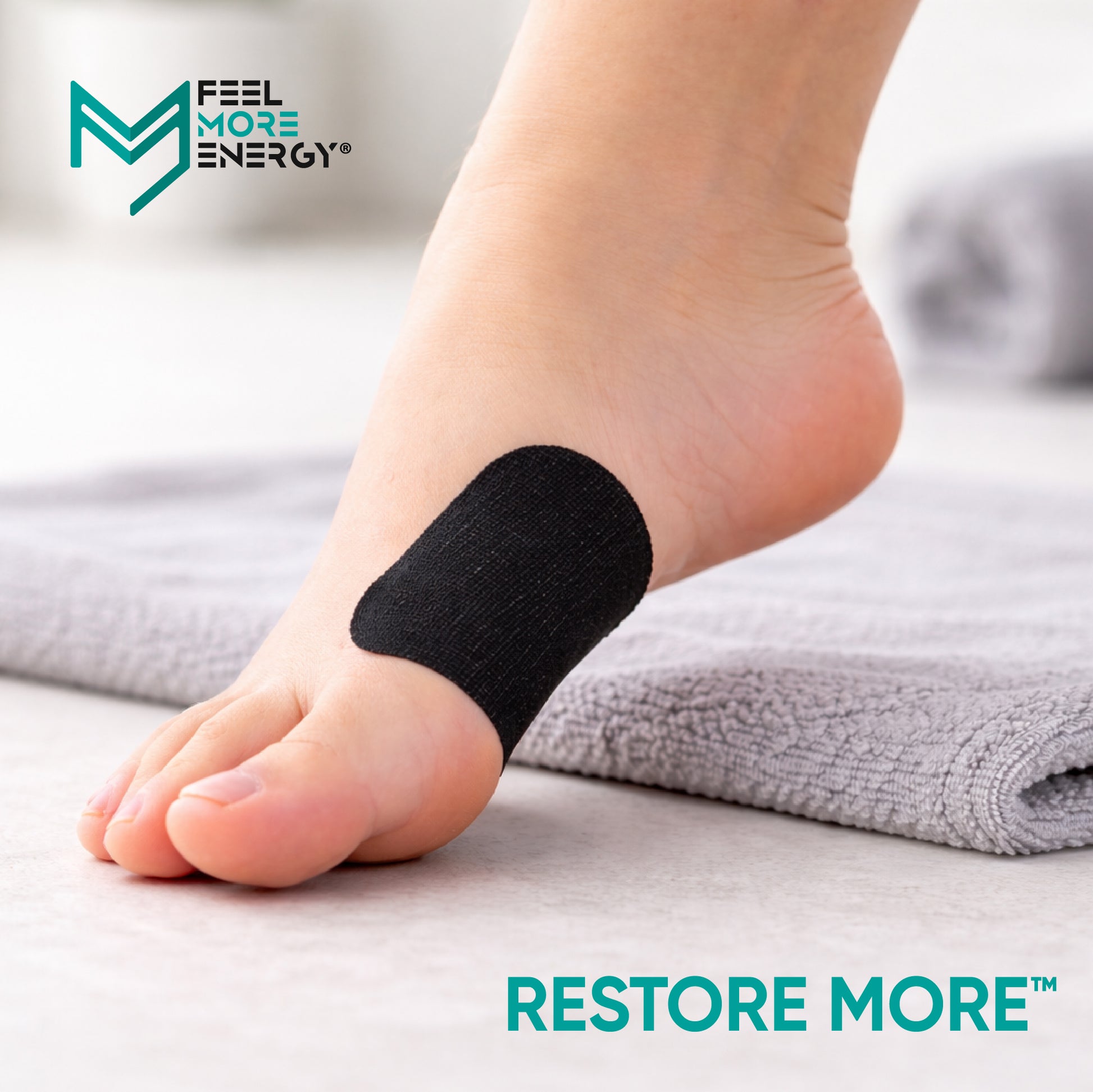 Foot with black bandage on toe, 'Feel More Energy' brand visible