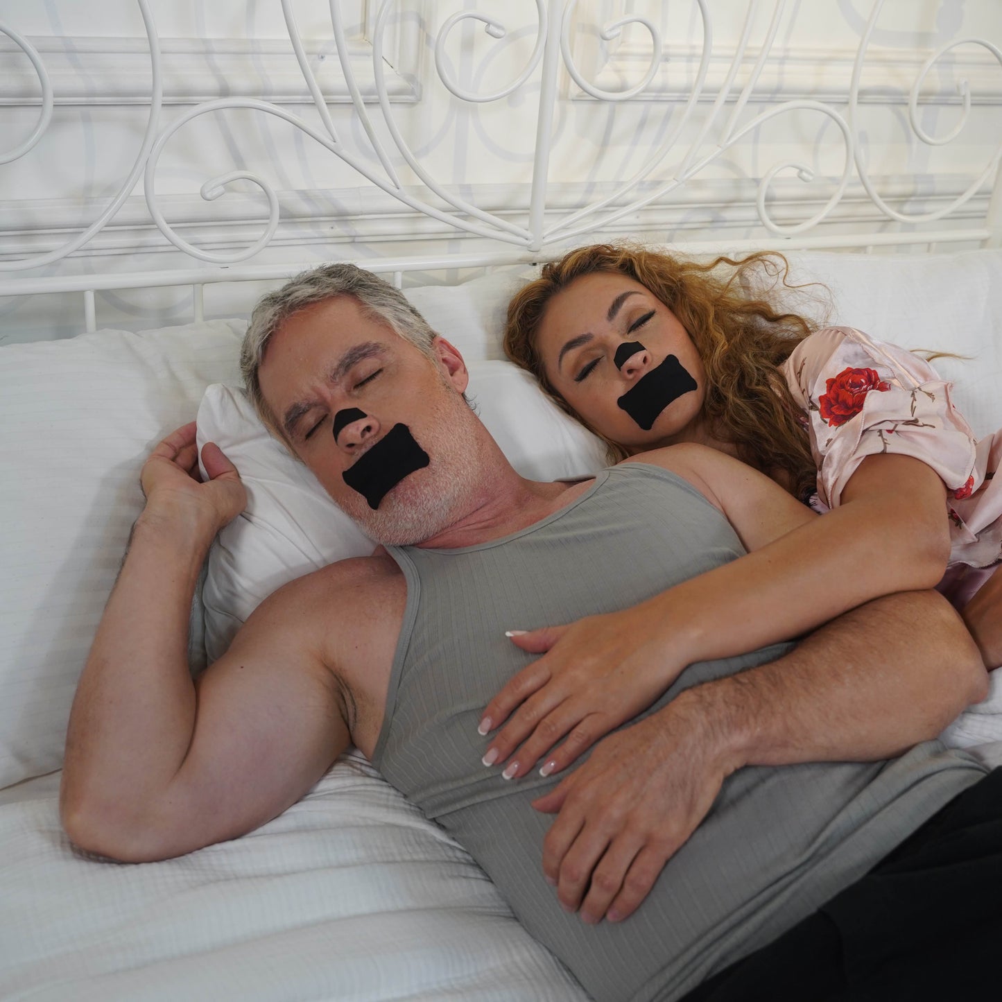  Man wearing Sleep-More mouth tape sleeping next to his partner — quiet nasal breathing for shared restful nights